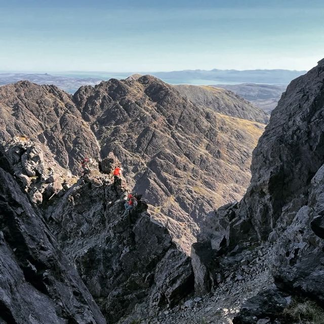 A climber picking a line along the jagged rock of the Cuillin Ridge on Skye