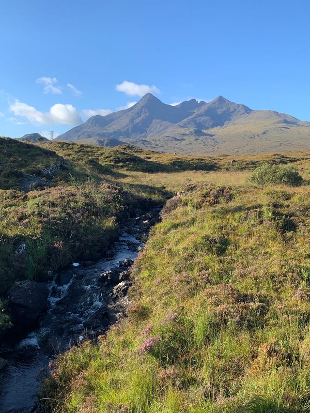 Looking across a Skye river and moorland to the Black Cuillin