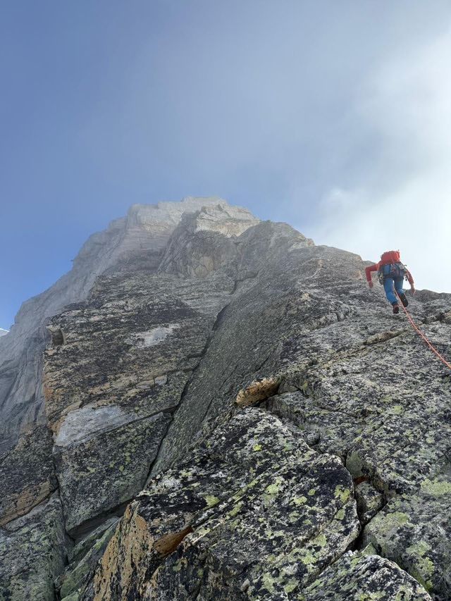 Dave scrambling up a steep rocky ridge